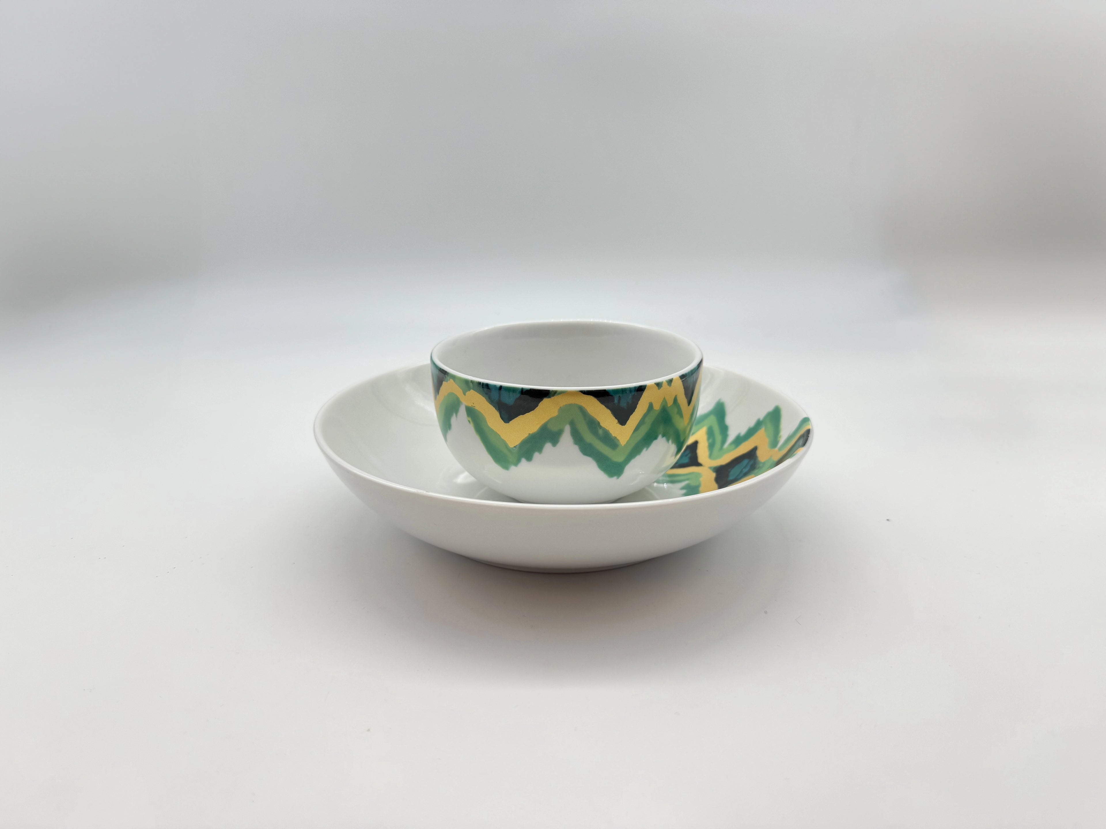 Aqua Zigzag porcelain dinnerware pieces stacked — bowl, deep plate, and dessert plate