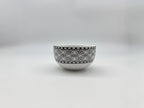 Front view of porcelain soup bowl with black lace pattern