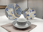 Lifestyle photo of blue and gold porcelain dinnerware set displayed on a table