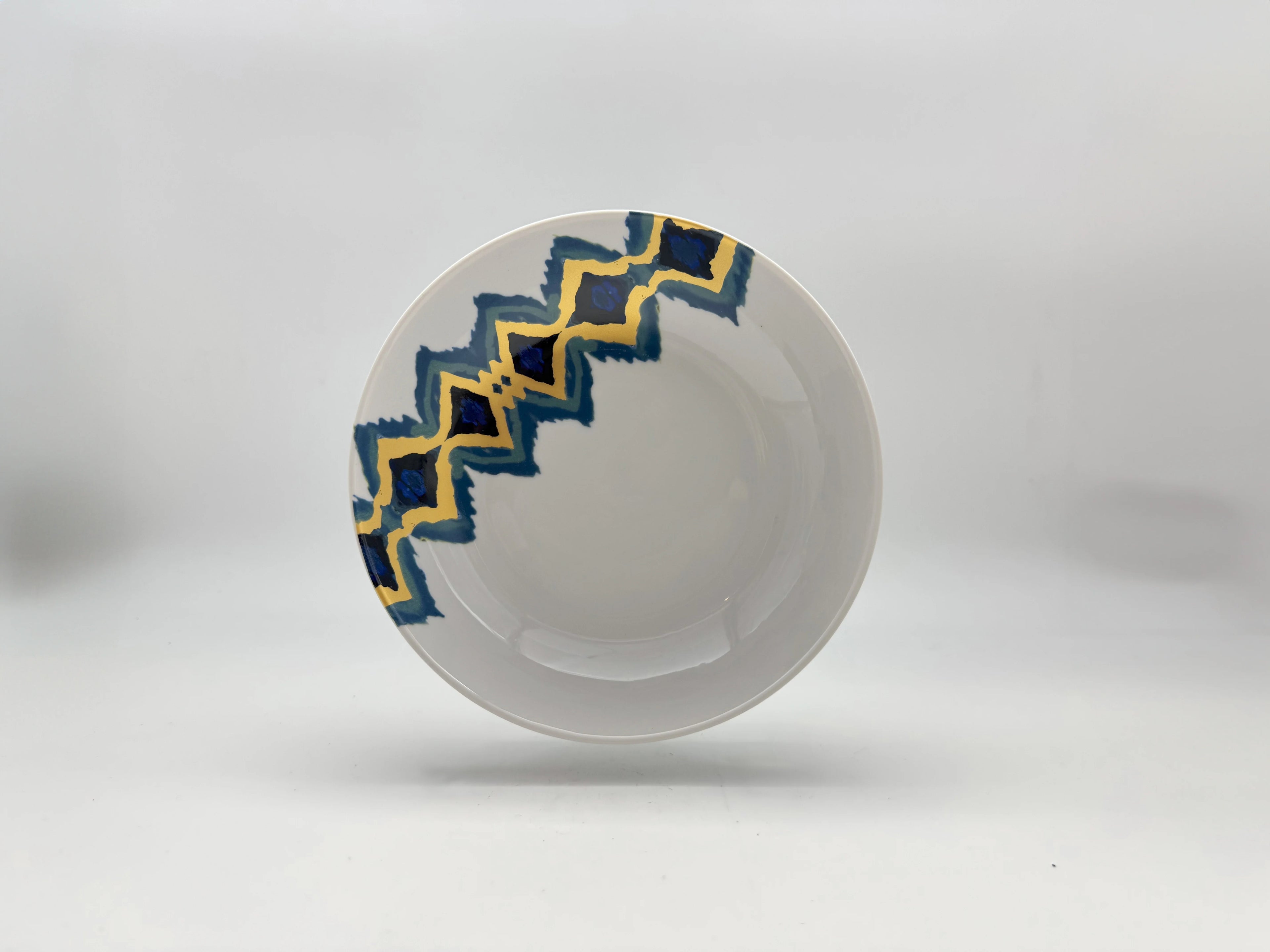 Blue Sahara deep plate with blue and gold patterned rim
