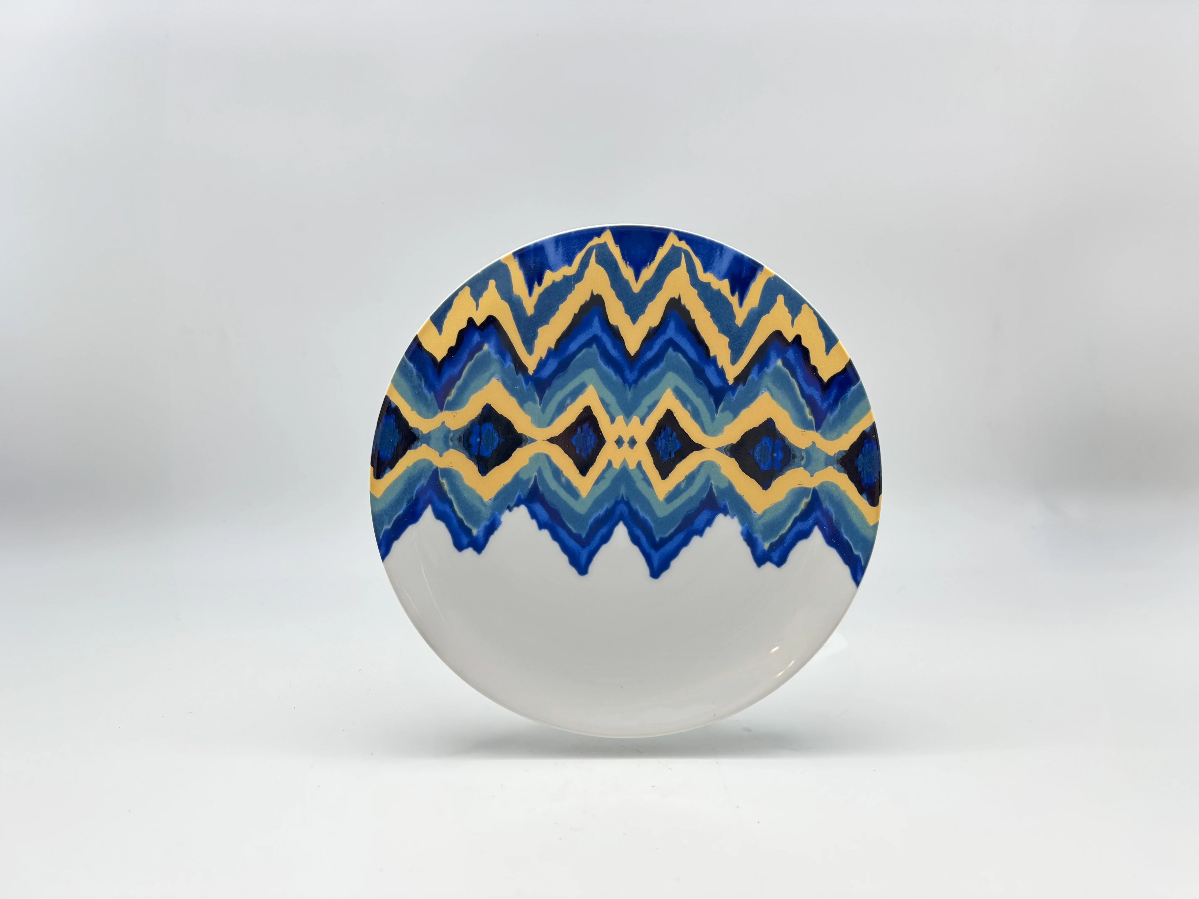 Blue Sahara dessert plate with blue and gold pattern on upper half