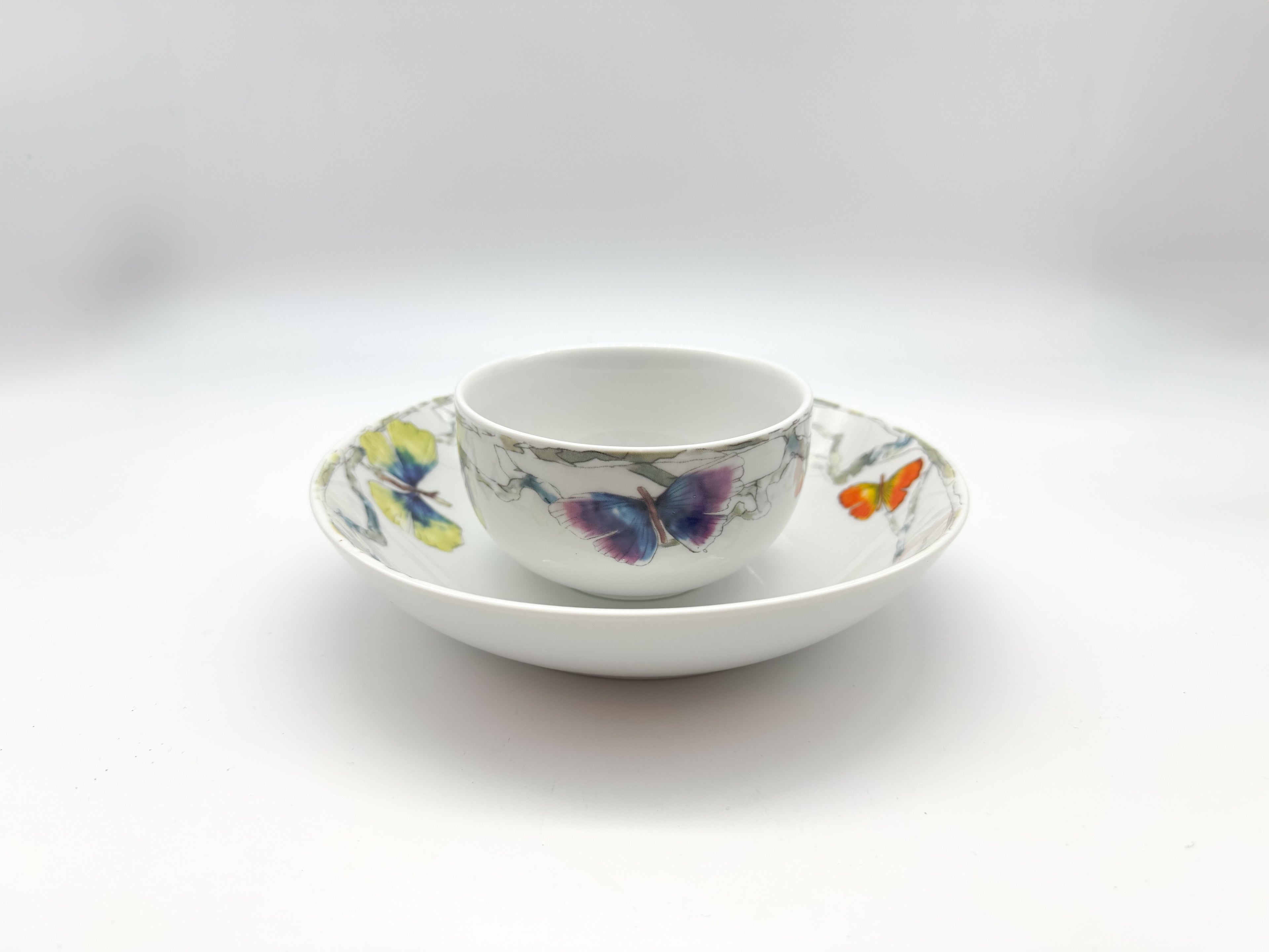 Butterfly porcelain soup bowl placed on a matching deep plate from the 24-piece dinner set