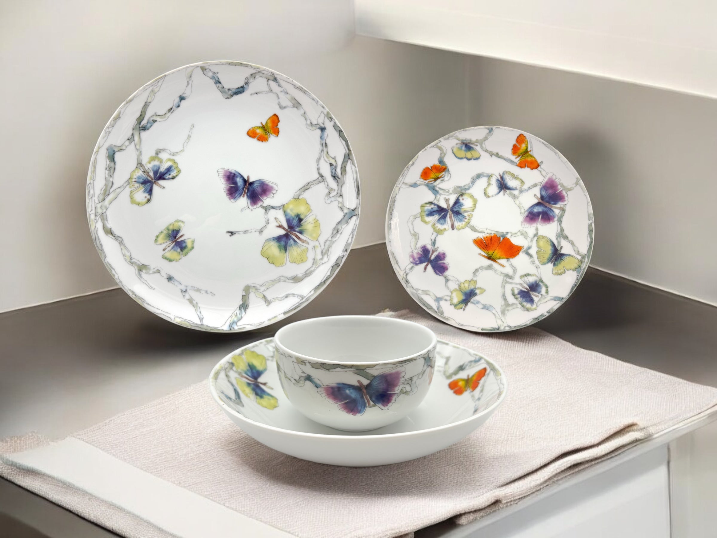 Butterfly porcelain dinnerware set with plates and bowl displayed in a kitchen lifestyle setting