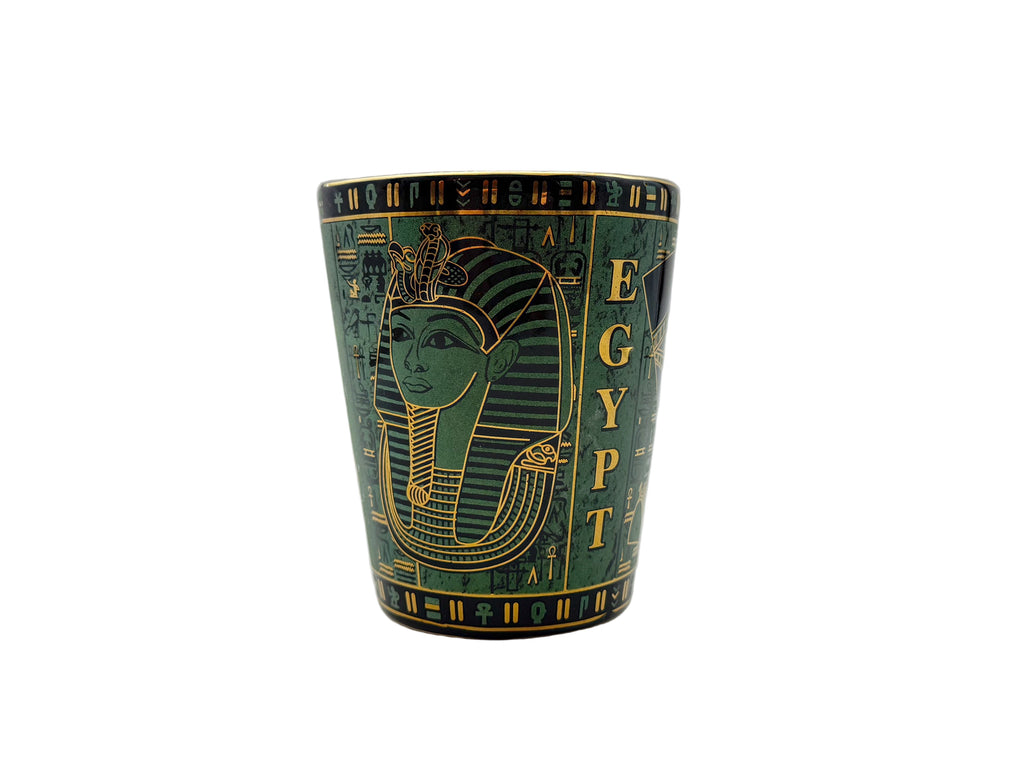 Porcelain mug with Egyptian pharaoh design and hieroglyphics in green and gold.