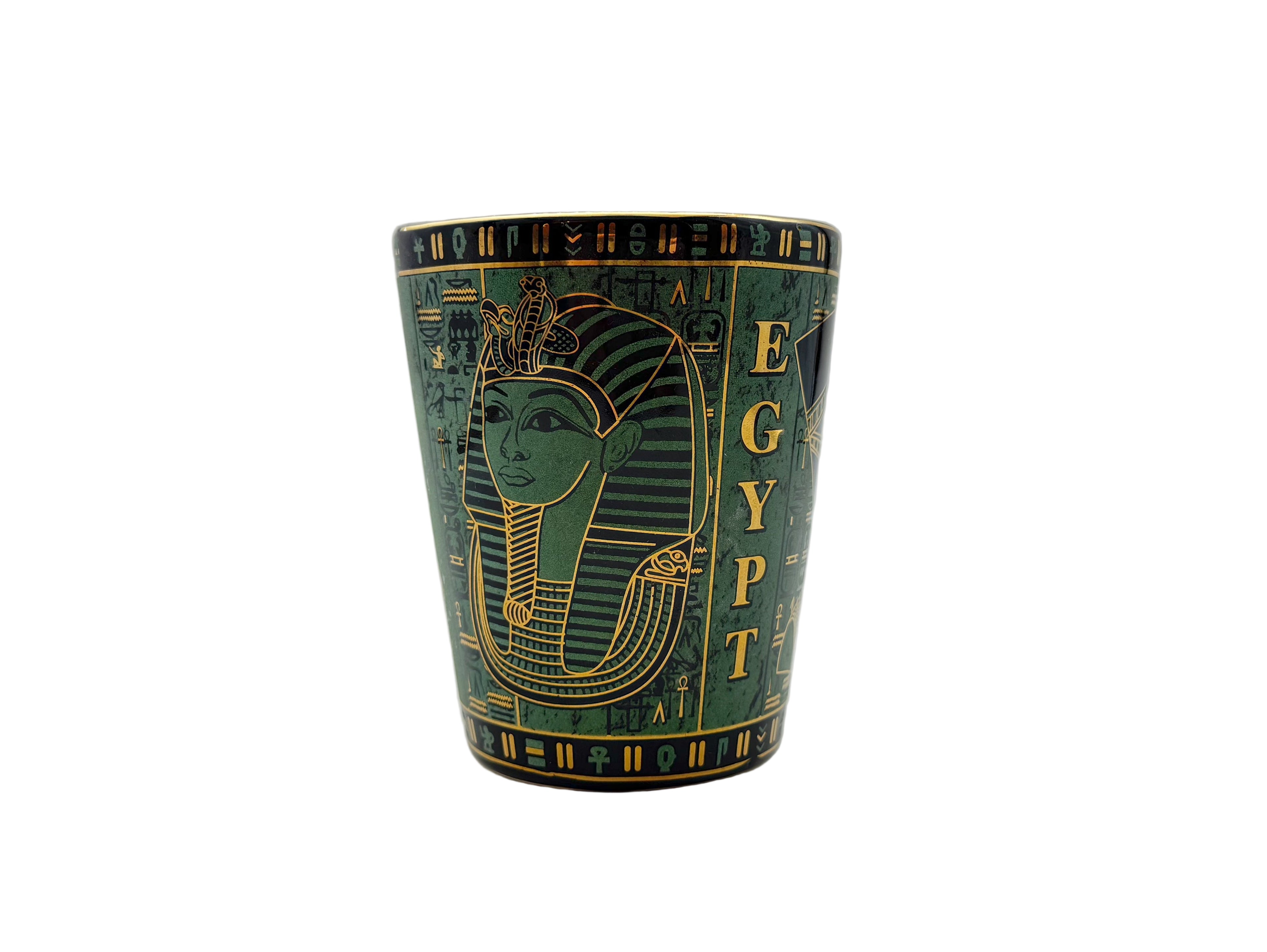 Porcelain mug with Egyptian pharaoh design and hieroglyphics in green and gold.