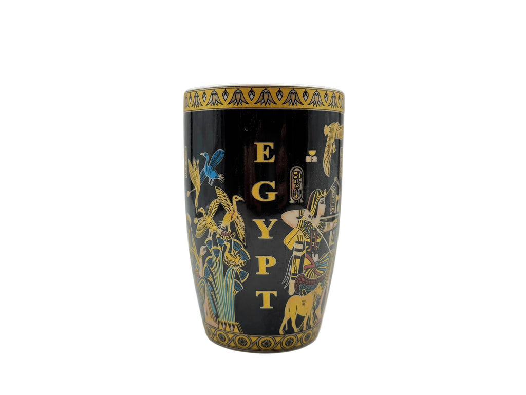 Side profile of the Mesu Hunter Mug showing the vertical ‘EGYPT’ lettering, golden birds, and papyrus plants on a glossy black surface