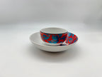 Porcelain bowl placed on matching deep plate in red and blue pattern