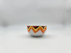 Front view of Sunset Zigzag porcelain soup bowl with warm-toned geometric design