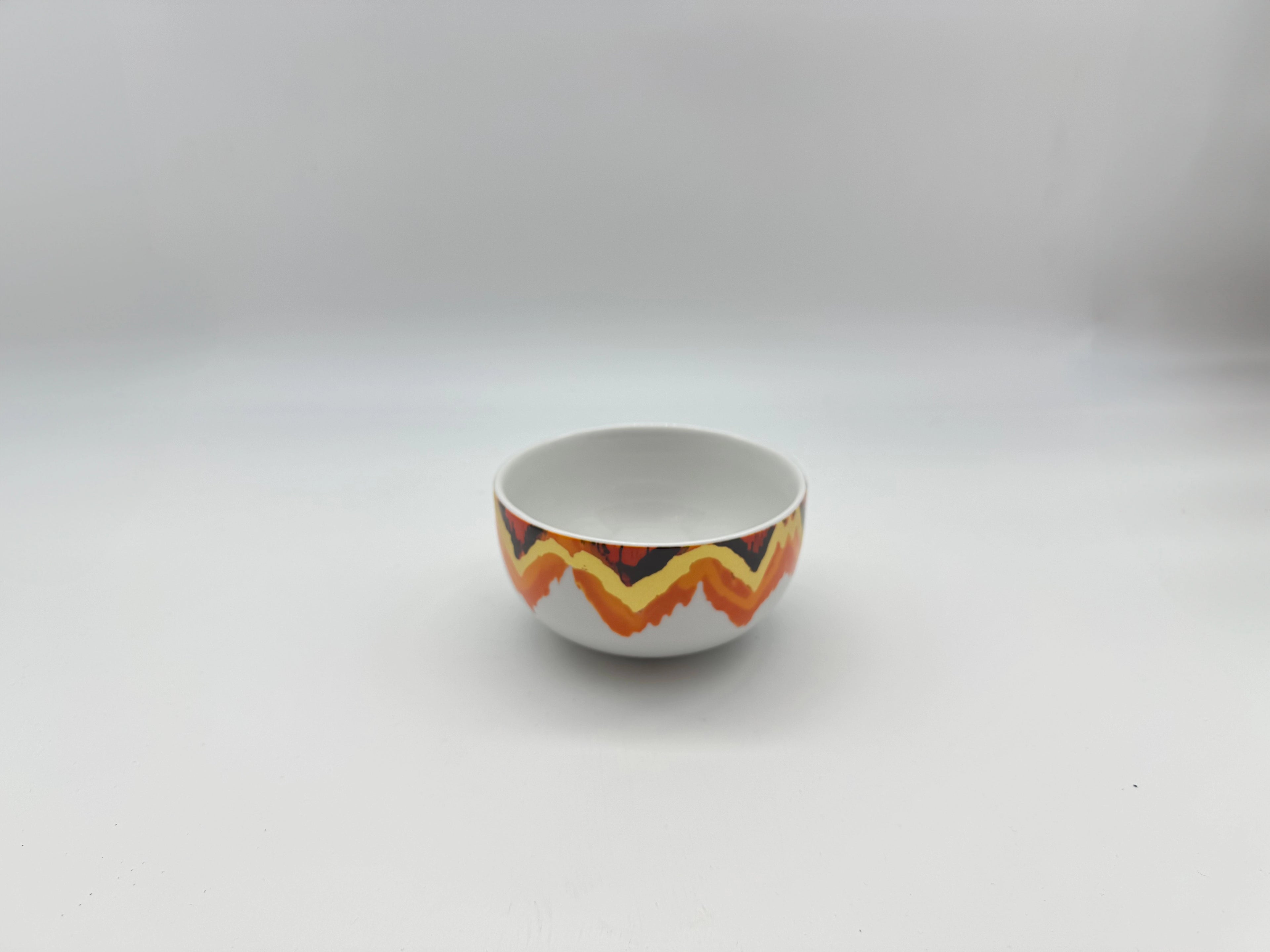 Porcelain soup bowl with Sunset Zigzag orange and gold patterned border