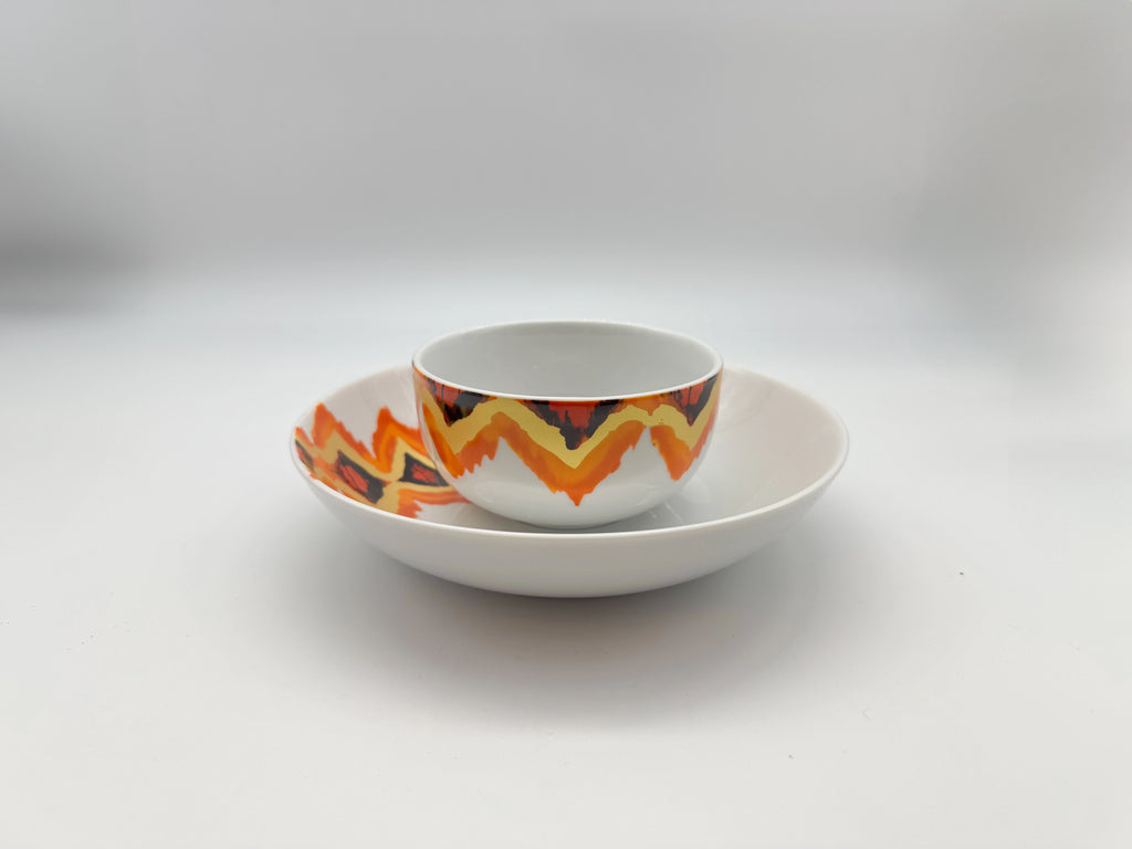 Sunset Zigzag porcelain bowl and plate stacking set with orange and red patterns