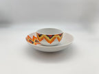 Sunset Zigzag porcelain bowl and plate stacking set with orange and red patterns